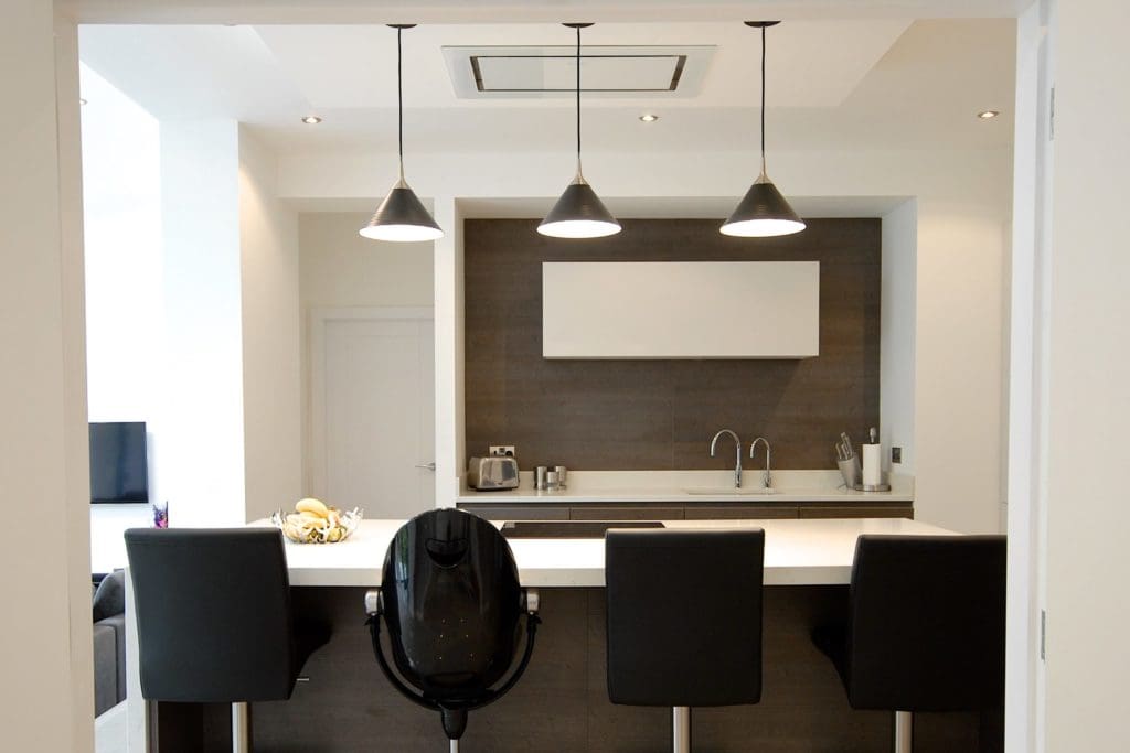 a kitchen with a lot of counter space and chairs.