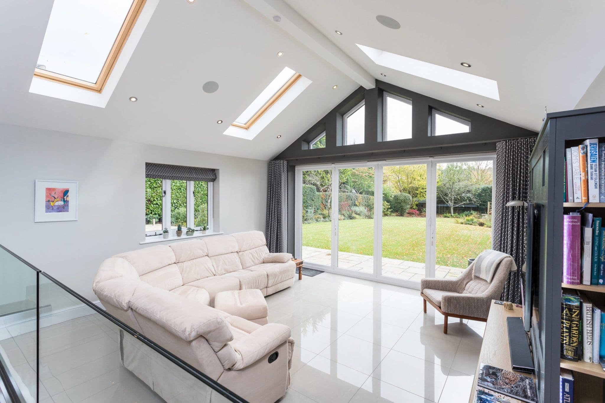 a living room filled with furniture and a large window.