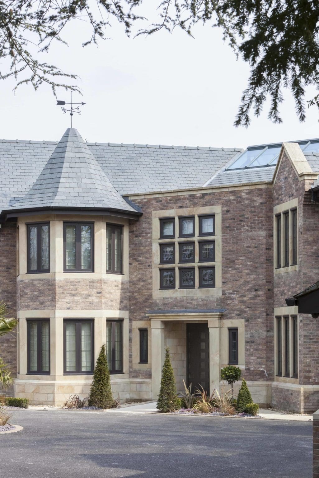 a large brick house with a blue roof.