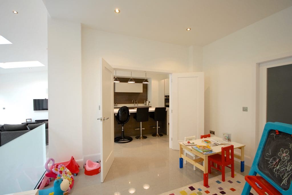 a child's playroom with a chalkboard and toys.