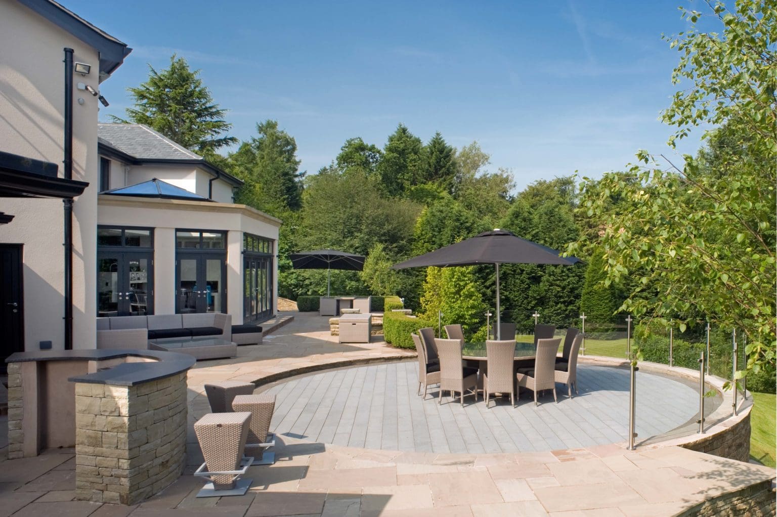 a patio with a table and chairs and an umbrella.