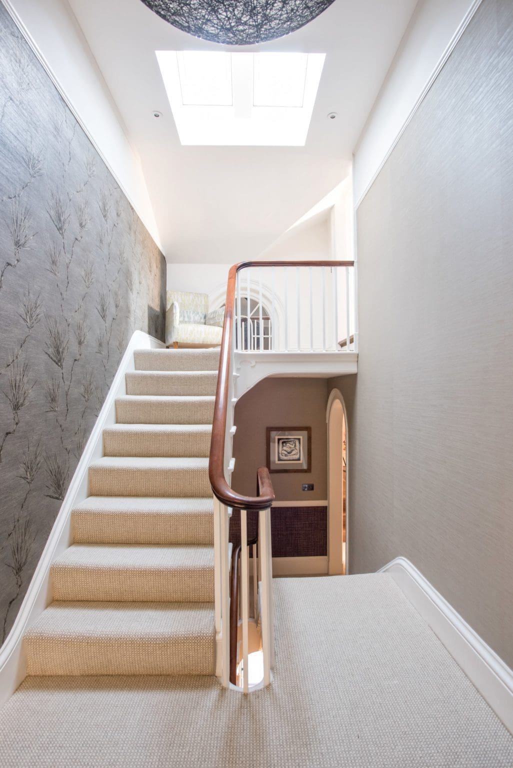 a staircase leading to a second floor with a skylight.