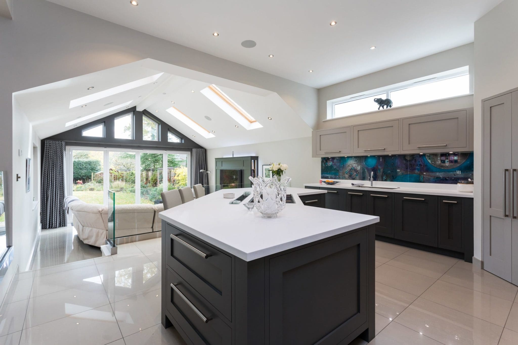 a large kitchen with a center island in the middle of the room.