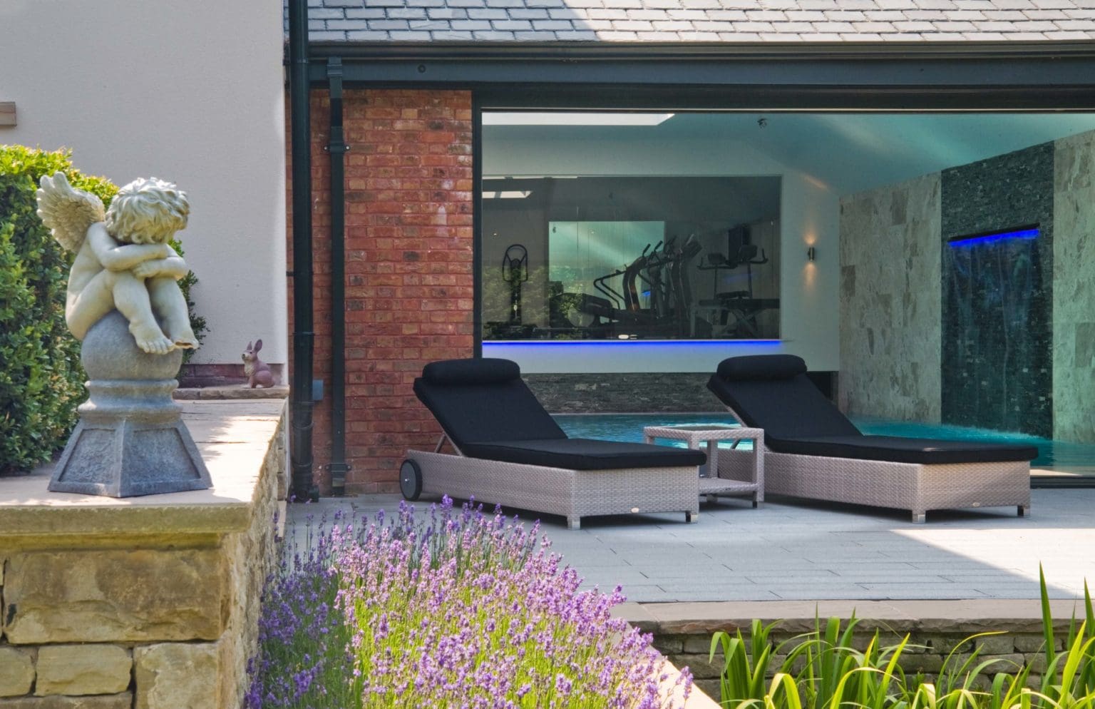 a couple of chairs sitting next to a pool.