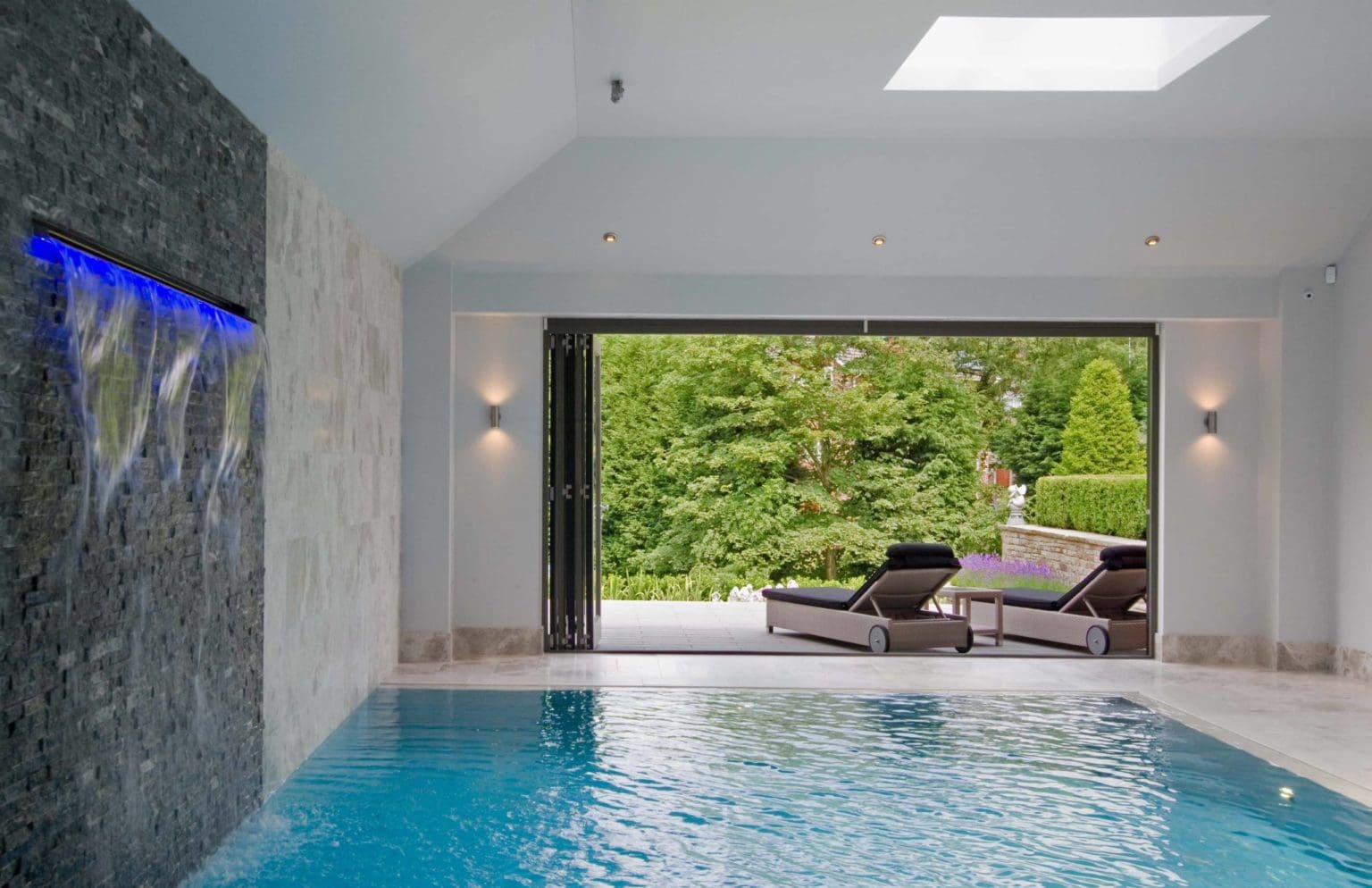 a large indoor swimming pool with lounge chairs.