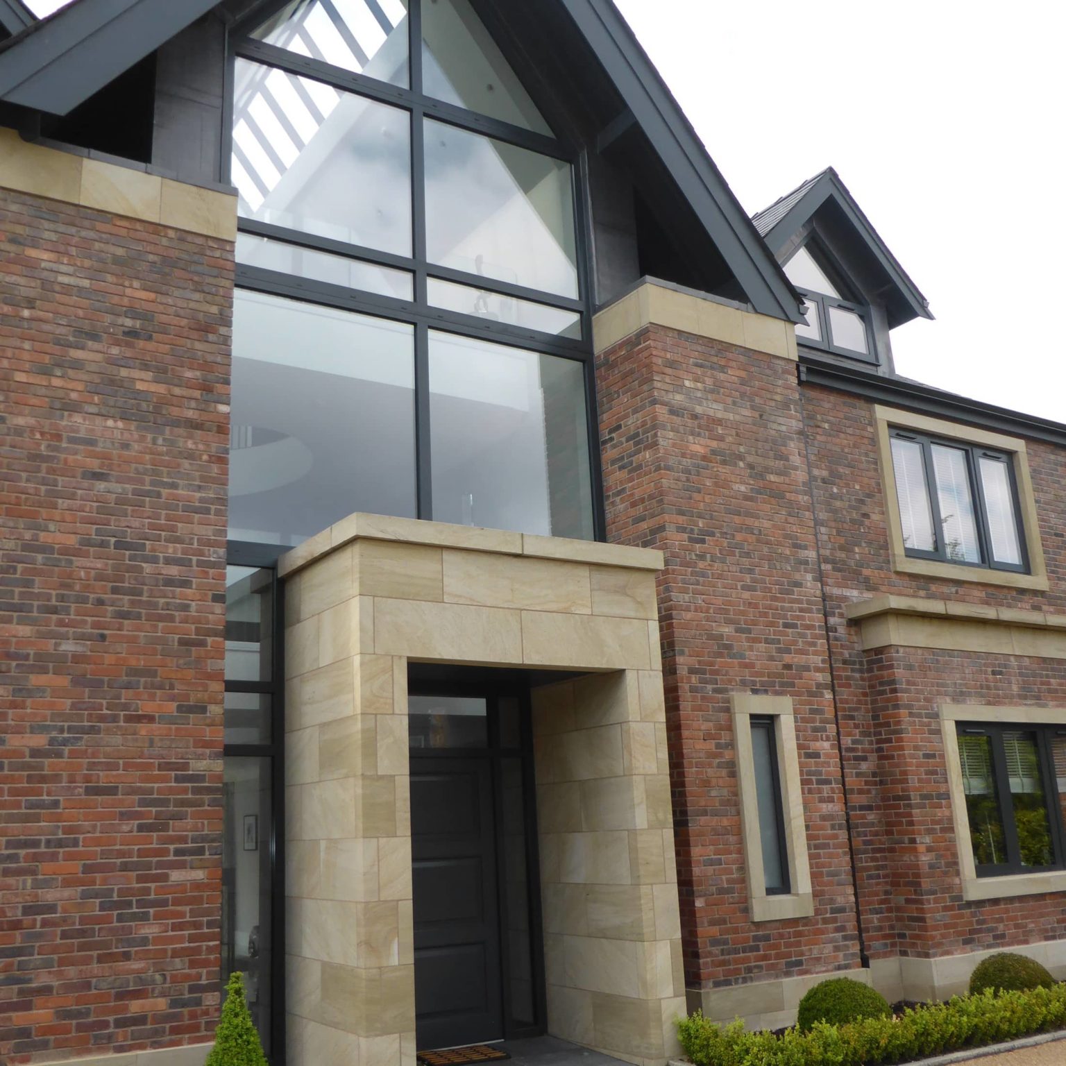 a brick building with a black door and windows.