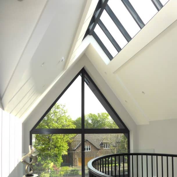 a room with a spiral staircase and a large window.