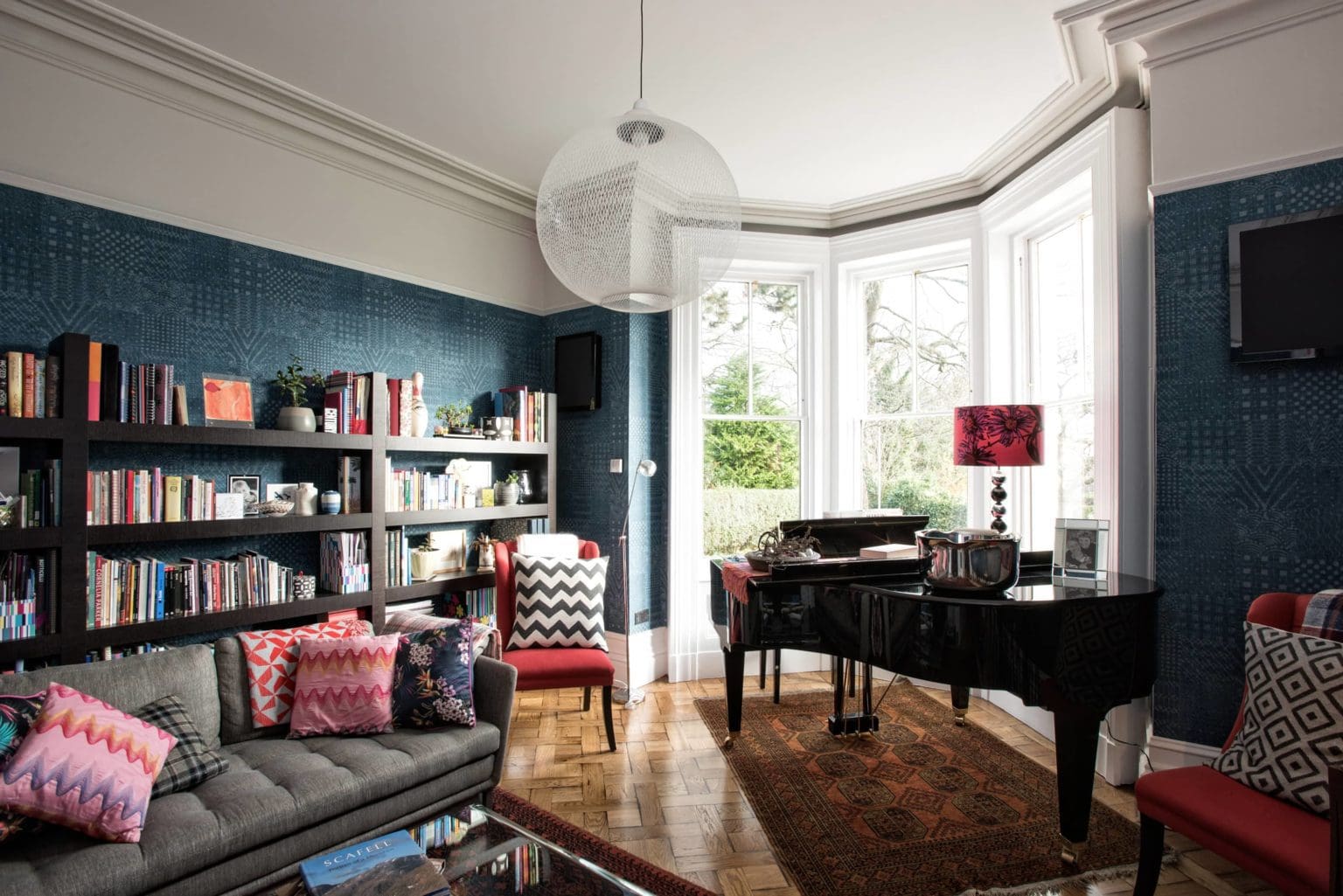 a living room filled with furniture and a piano.