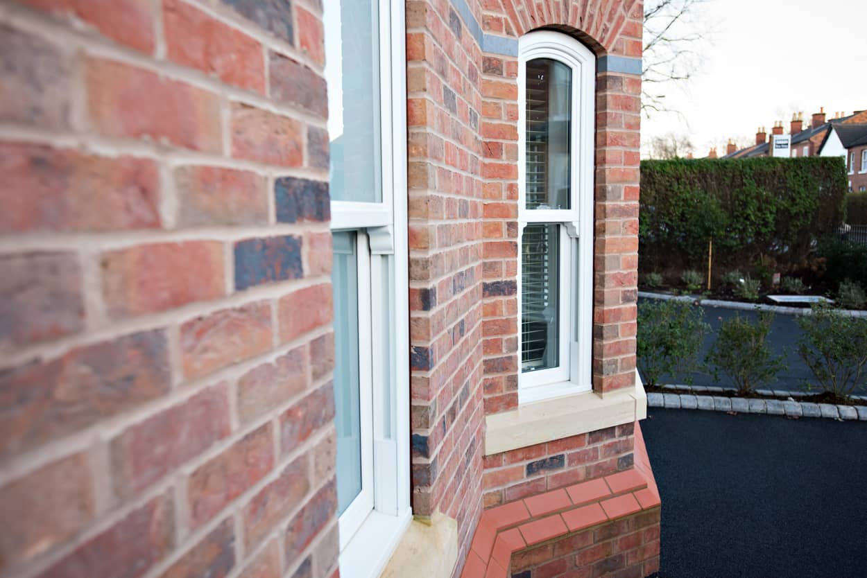 a red brick building with a white window.