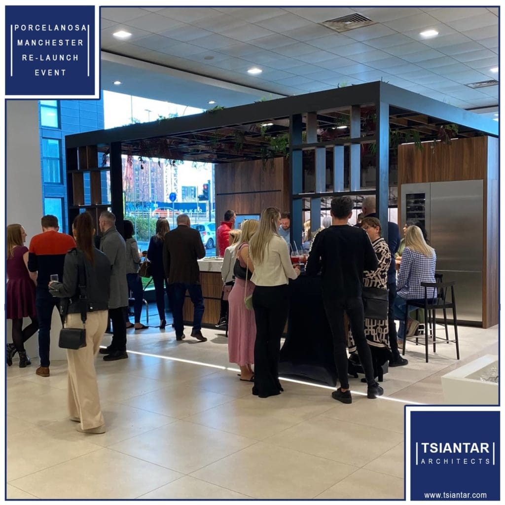 a group of people standing around in a room.