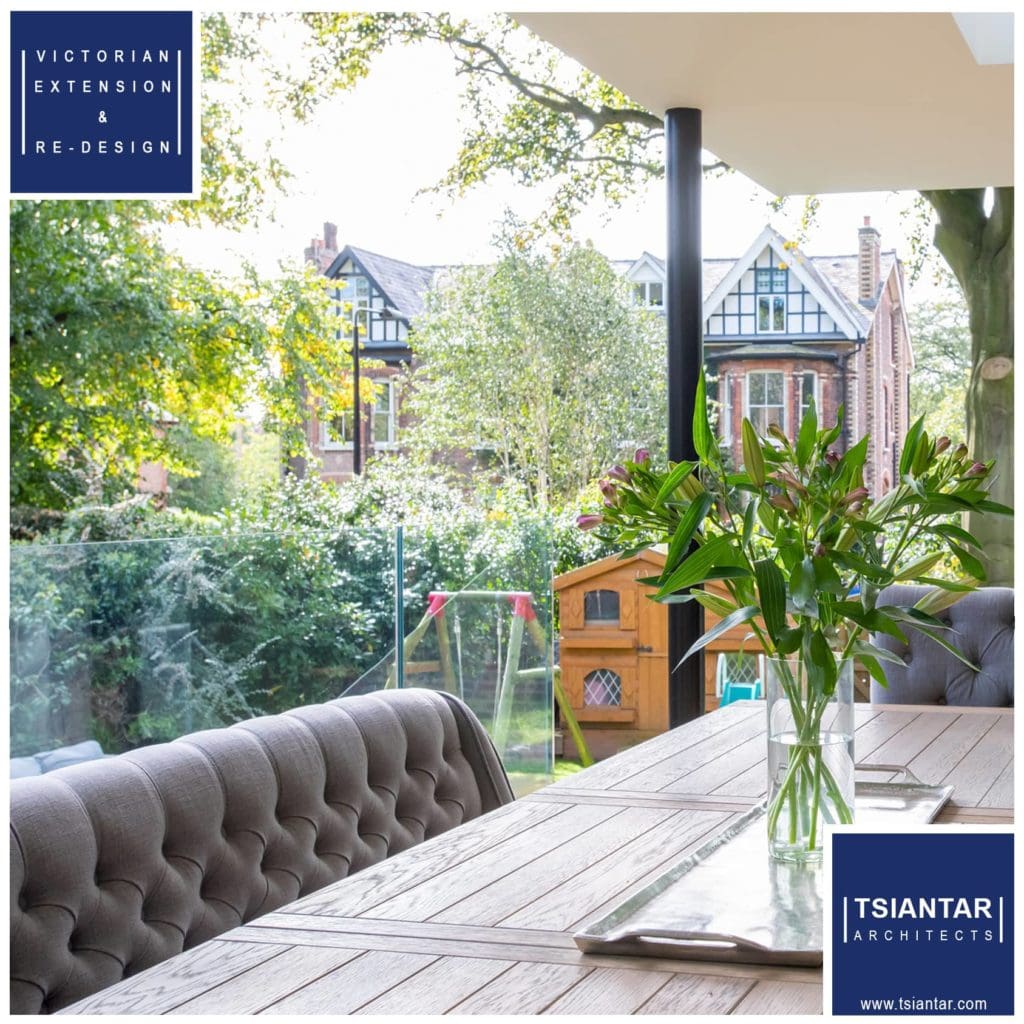 A dining room with a table and chairs and a view of a garden.