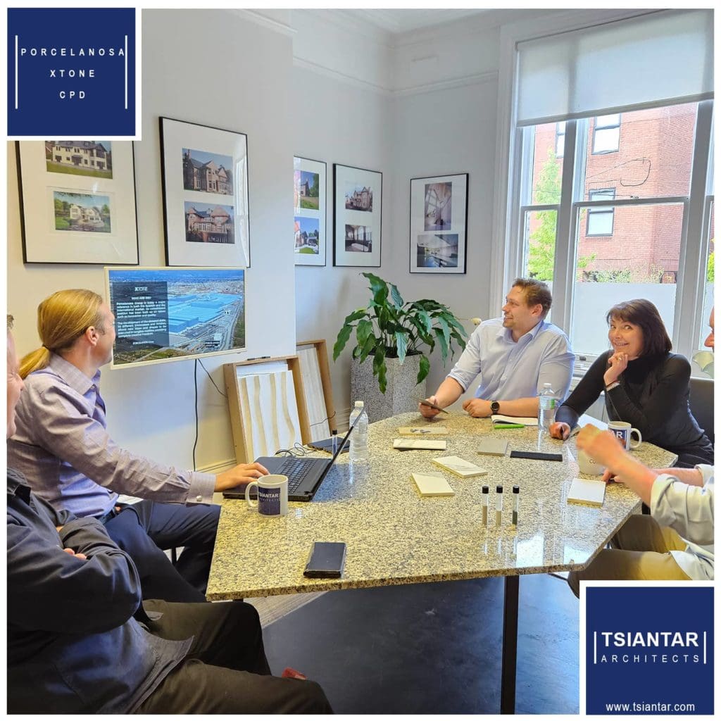 A group of people sitting around a table in a conference room.
