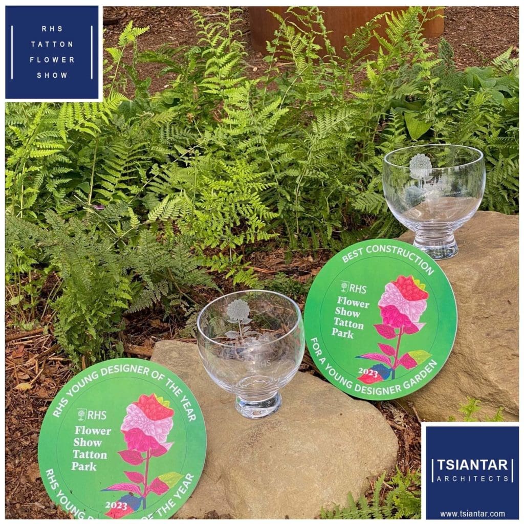 A pair of glasses on a rock with ferns in the background.