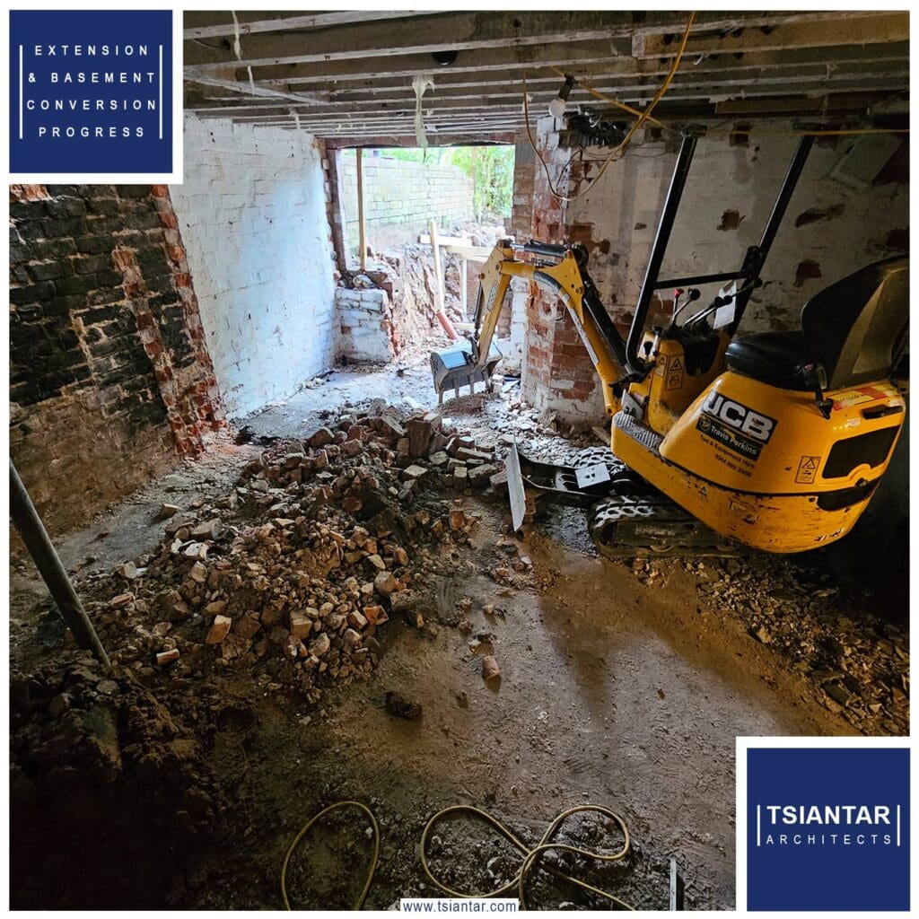 A yellow excavator is in the middle of a NEW PROJECT room.