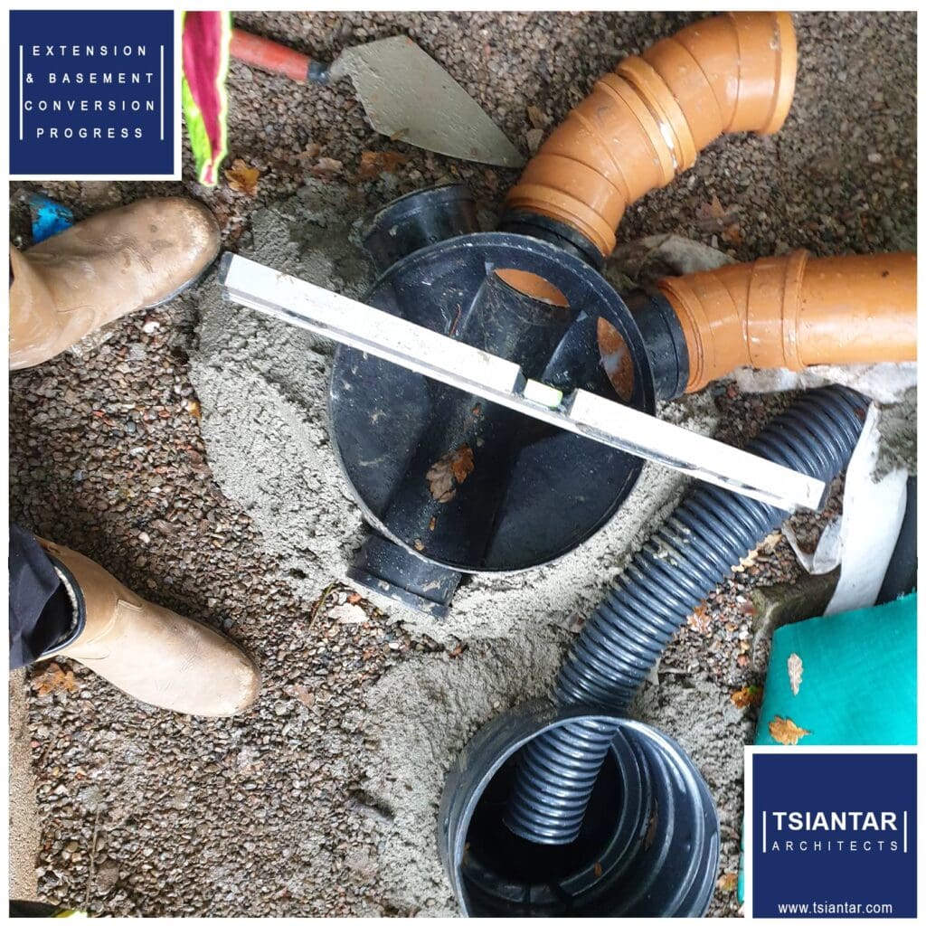 A person is standing next to a hose, making progress with the pipe.