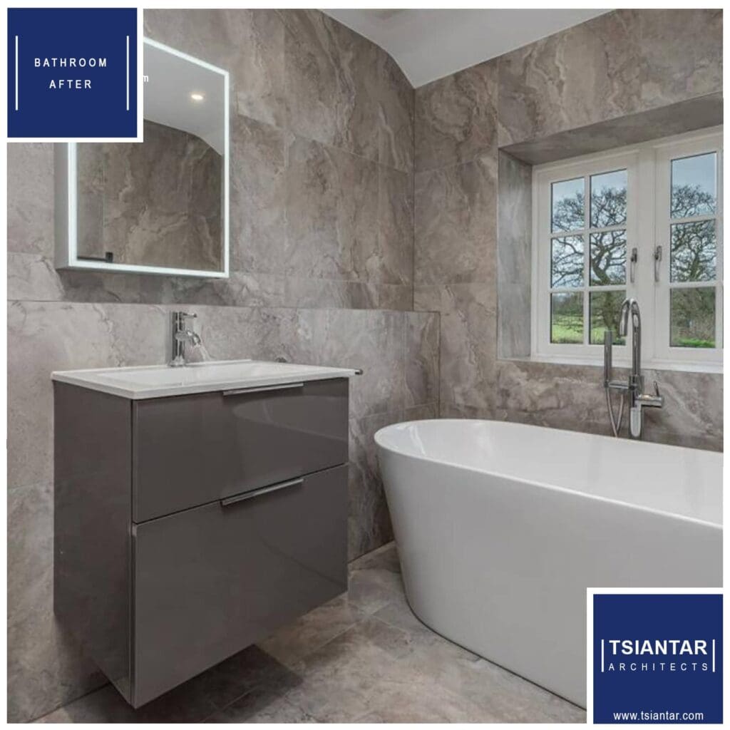 Modern bathroom remodeling with gray stone tiles featuring a wall-mounted vanity and a freestanding bathtub.