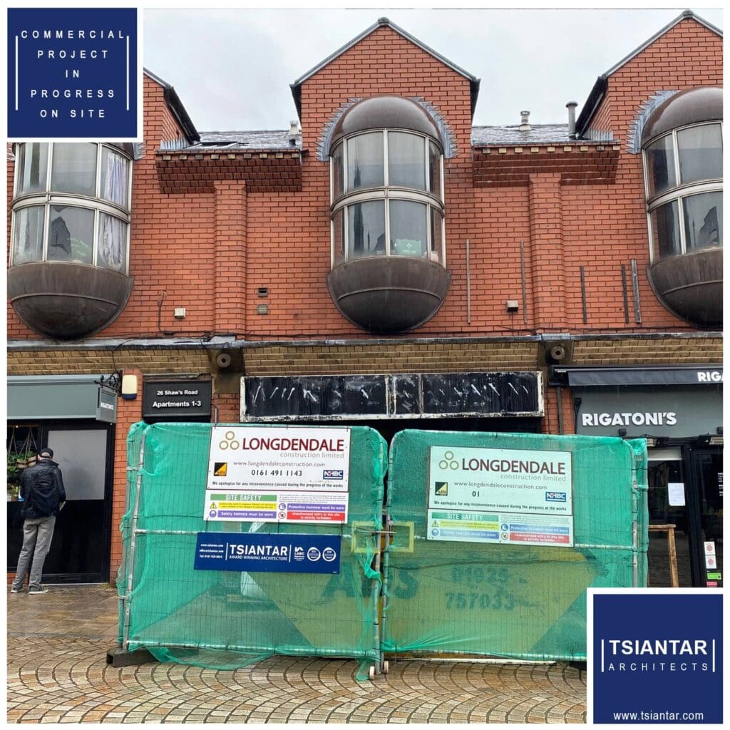 Image of an ongoing construction project by Tsiantar Architects at a building with two large bay windows. The construction site is fenced off with green barriers bearing the Longdendale logo and signage.
