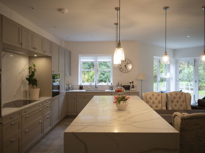 A kitchen with a marble counter top.