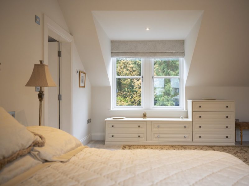 A bed in a room with a window.