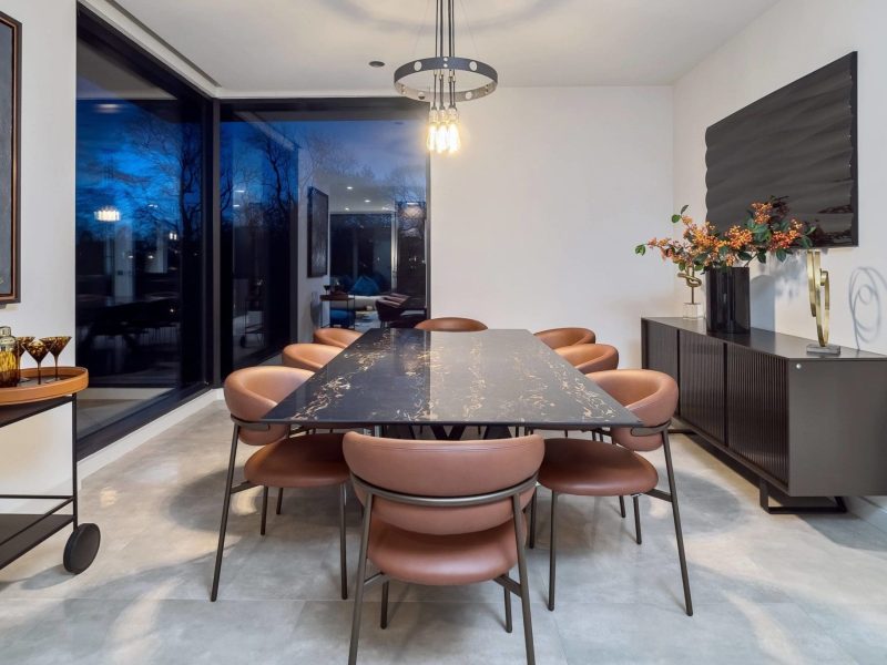 a dining room with a large table and chairs.