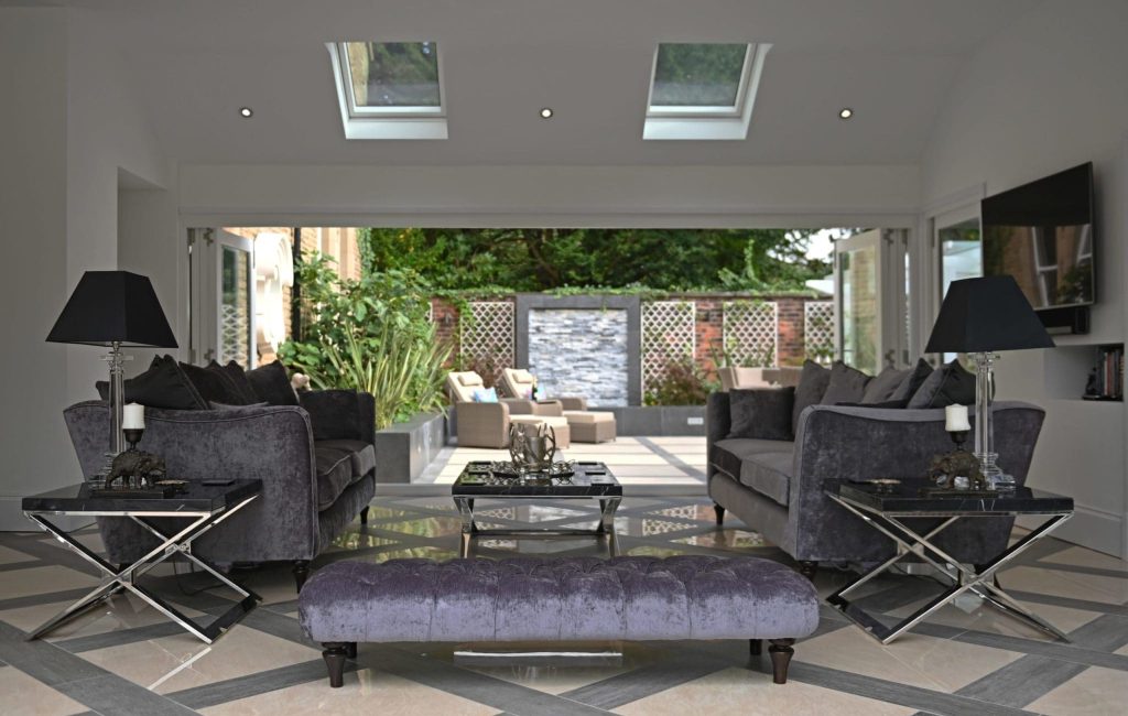 a living room filled with furniture and a large window.