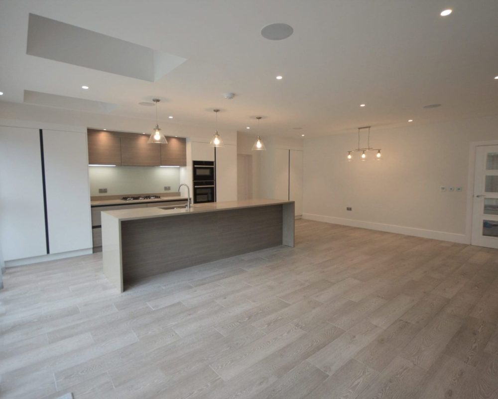 a kitchen with a center island in the middle of a room.