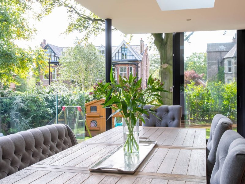 a wooden table with a vase of flowers on top of it.