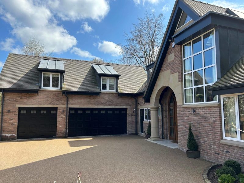 a large brick house with two garages.