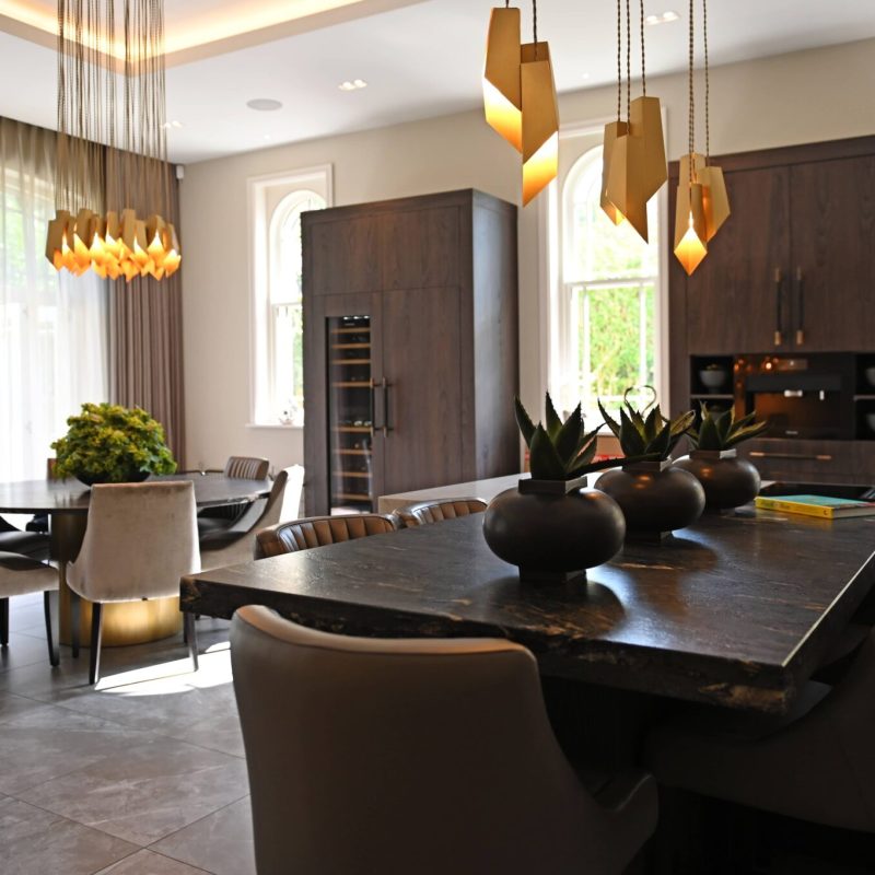A modern kitchen with a dining table and chairs undergoing renovation.